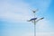 Solar panels and wind turbine and blue sky background