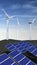 Solar panels and wind turbines with a blue sky