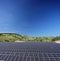 Solar photovoltaic cell panels on field under blue sky at Macedonia, shot with a tilt and shift lens