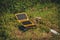 Solar portable usb panel for charging power bank on green grass. Obtaining energy in wild