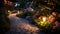 Solar-powered outdoor lighting illuminating a garden pathway, lush garden with flowers and plants. Solar-powered