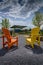 Solar rooftop amphitheater between two painted wooden Adirondack chairs