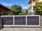 Solar sliding gate with solar panels at house driveway