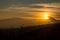 Solar sphere above the volcanoes at dawn