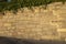 Sold rock stone wall with cement joints golden sunlight coloring