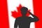 Solder silhouette on blur background with Canada flag