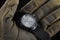 Soldier arm holding black tactical watch close up