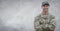 Soldier arms folded against white wall with grunge overlay