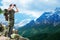 Soldier with backpack looking to binocular