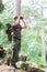 Soldier with binocular and backpack in forest