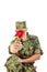 Soldier in camouflage uniform kneeling holding flower