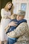 Soldier Embracing Son Before Departing While Mother Looking At Them