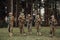 Soldier fighters standing together with guns. Group portrait of US army elite members, private military company