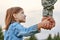 Soldier holding hand of little girl, close up.