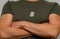 A soldier in a T-shirt with a military name medallion around his neck. Strong physique of a military pensioner.