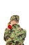 Soldier with turned back holding red rose over shoulder