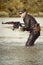 Soldier in uniform attacking in lake with assault rifle