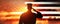 Soldier and USA flag on sunrise background