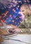 Soldier using a laptop with a fireworks in background