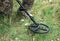 Soldier using a metal detector in fields. Ukrainian Explosive Ordnance Disposal Officer detecting metal by metal detector device