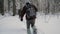 Soldier with weapons in cold forest. Winter warfare and military concept. Clip. Soldiers in winter forest on skis with