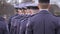 The soldiers in blue uniform are standing at the ceremony.