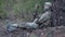 Soldiers in camouflage with military weapons rest in the shelter of the forest, the military concept