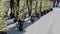 Soldiers with camouflage uniform and black boots marching in formation on parade at national holiday. Special police, guards and a