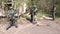 Soldiers in military uniform with weapon walk on background of ruined house.