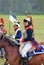 Soldiers-reenactors ride horses.