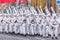 Soldiers skiers in white winter camouflage suits parade across the square