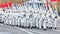 Soldiers skiers in white winter camouflage suits parade across the square