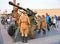 Soldiers in uniform leads to the stowed position the antiaircraft guns on the Palace square on the background walking people