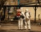 Soldiers in a white protective suits sprays the streets and courtyards with disinfectant to decontaminate the city of the