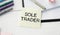SOLE TRADER, text on white notepad on craft