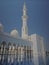 A solemn and fantastic view of Sheikh Zayed Mosque with tall tower and arc corridor, Abu Dhabi