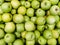 Solid background of green apples in a crate