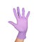 Solid fist or anger gesture in latex surgical gloved sign against white background. Hand in a purple latex glove isolated on white