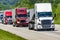 A solid line of eighteen-wheelers barrel down an interstate highway in Tennessee