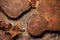 Solid oak cutting board and pine tree bark on rust metal background.