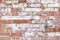 Solid rustic background of brick wall looks destroyed and has peeling old paint. Flat layer for mock up and template or