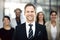 With a solid team, anything is possible. Cropped portrait of a group of businesspeople standing in the office.