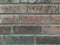 Solid wall with grey bricks in vintage style as grey stonewall background or wallpaper with urban house architecture seamless aged