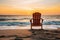 A solitary beach chair facing the ocean at sunrise, inviting relaxation and contemplation