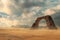 A solitary black arch stands tall amidst a sandy backdrop under a dramatic cloudy sky. Concept