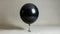 Solitary Black Balloon Floating in Isolation on a Cutout Background