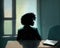 A solitary black woman sits in a conference room the light from the window casting long shadows across the walls as she