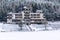 Solitary building in beautiful snowy winter forest landscape, frozen Brezova dam