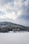 Solitary building in beautiful snowy winter forest landscape, frozen Brezova dam