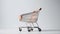 A solitary empty market trolley sits against a clean white backdrop, awaiting its next load